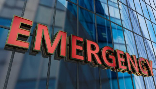 ểmgency: A thorough guide to dealing with a situation of urgency. Person preparing an ểmgency kit with first aid, flashlight, and food supplies